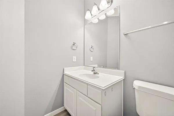 a bathroom with a sink a mirror and a toilet