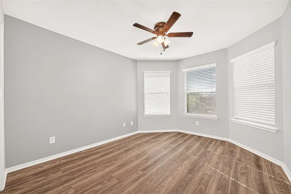 a view of a livingroom with a ceiling fan and window