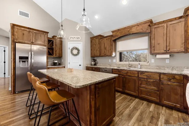 a kitchen with stainless steel appliances granite countertop a sink and cabinets