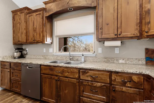 a kitchen with stainless steel appliances granite countertop a stove a microwave and cabinets