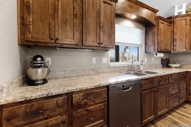 a kitchen with stainless steel appliances granite countertop a stove microwave and cabinets