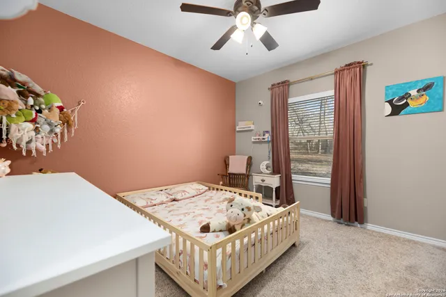 a spacious bathroom with a granite countertop sink a toilet and a mirror