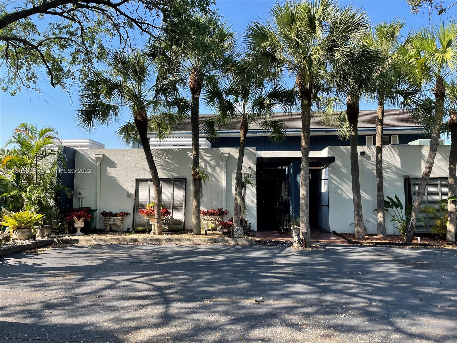 6411 Windmill Gate Road Miami Lakes, FL 33014 - Photo 1 of 23 front view of a building with a street