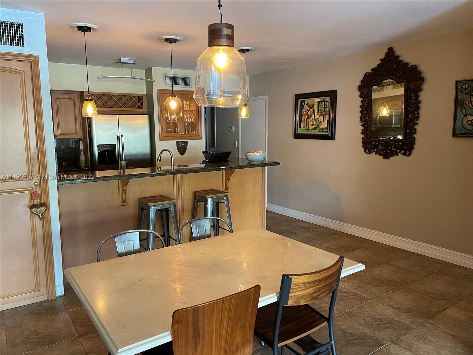 6411 Windmill Gate Road Miami Lakes, FL 33014 - Photo 11 of 23 a view of a dining room and a table and chairs
