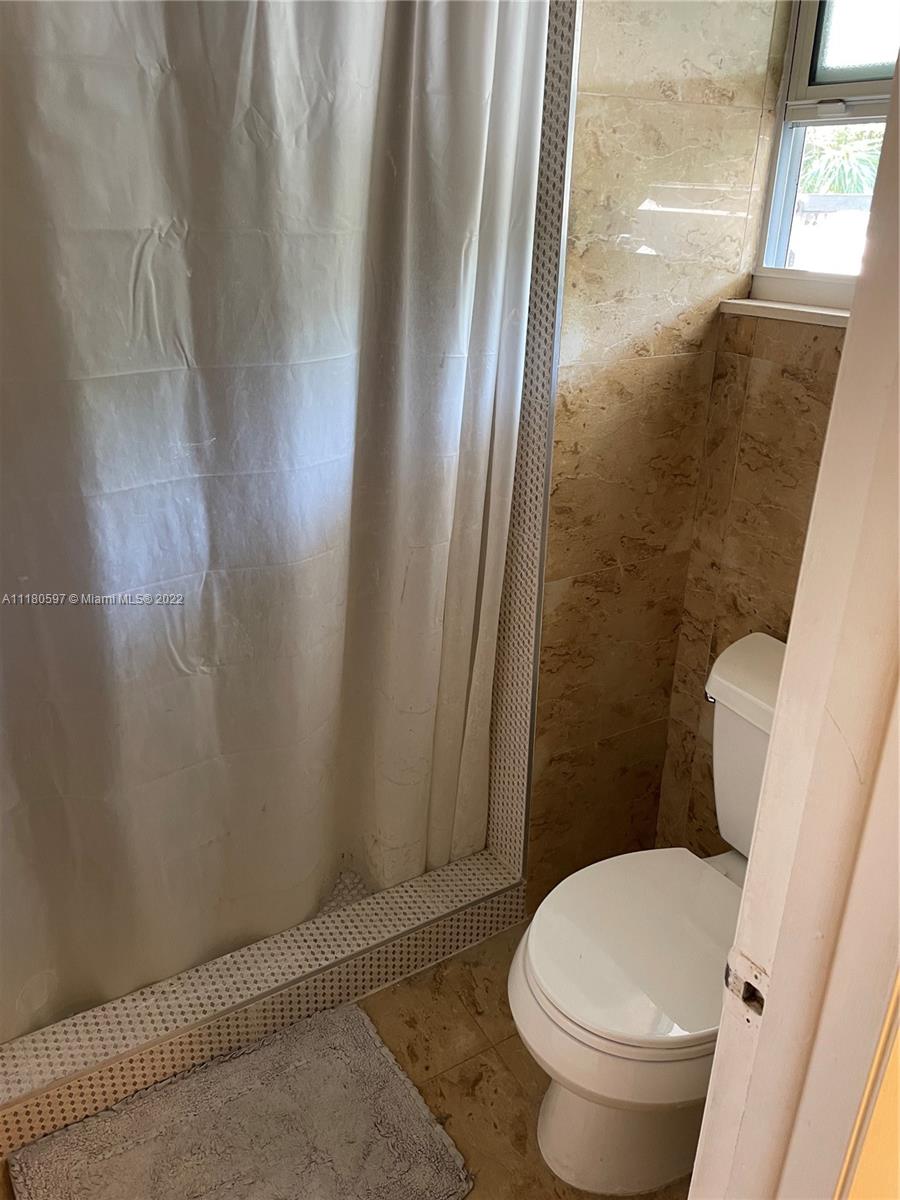 6411 Windmill Gate Road Miami Lakes, FL 33014 - Photo 16 of 23 a bathroom with a toilet and a shower