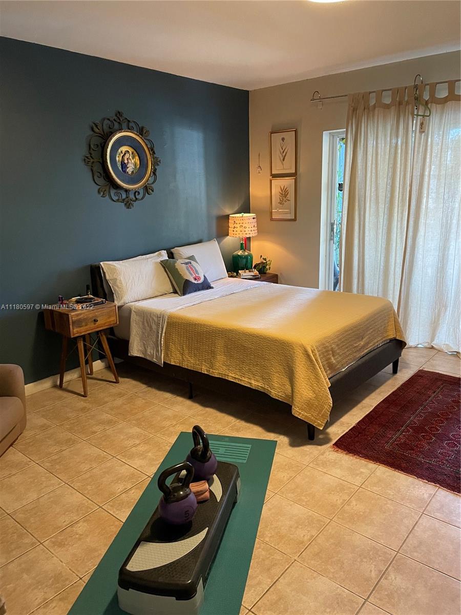 6411 Windmill Gate Road Miami Lakes, FL 33014 - Photo 19 of 23 a bedroom with two beds and a lamp