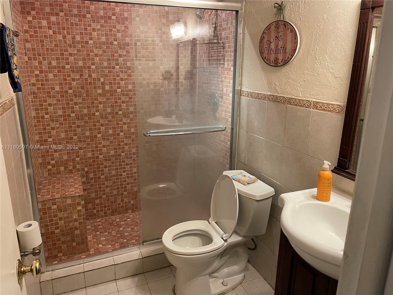 6411 Windmill Gate Road Miami Lakes, FL 33014 - Photo 21 of 23 a bathroom with a toilet and a shower