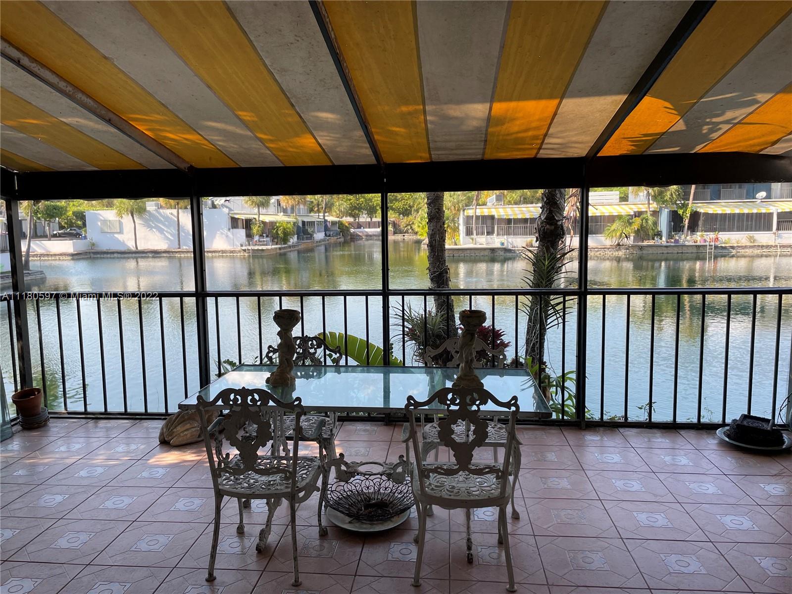 6411 Windmill Gate Road Miami Lakes, FL 33014 - Photo 23 of 23 a view of two chairs and table in the patio