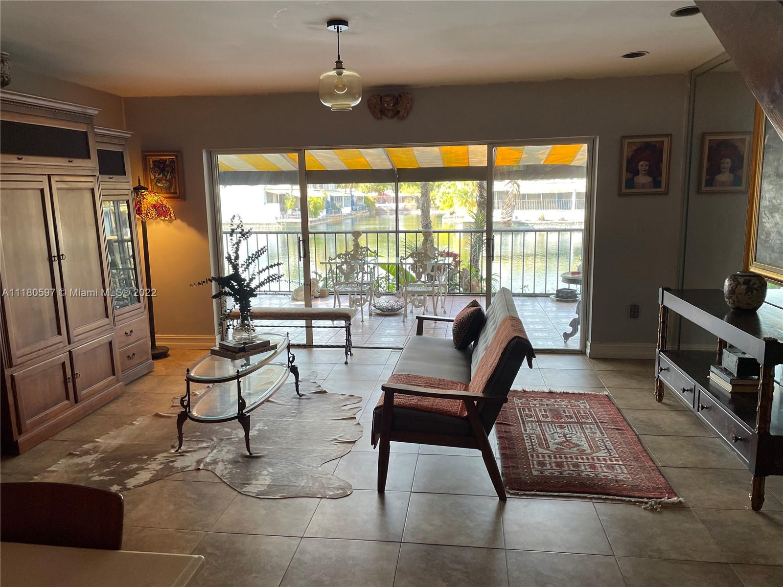 6411 Windmill Gate Road Miami Lakes, FL 33014 - Photo 4 of 23 a living room with furniture and a flat screen tv