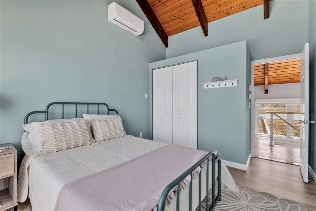 90 Salt Marsh Road East Sandwich, MA 02537 - Photo 35 of 40 a bedroom with a bed and wooden floor