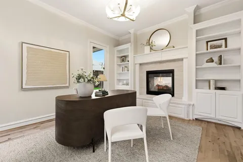a living room with furniture a fireplace and wall paintings