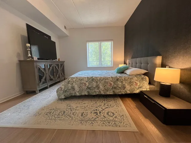 a bedroom with a bed and flat screen tv