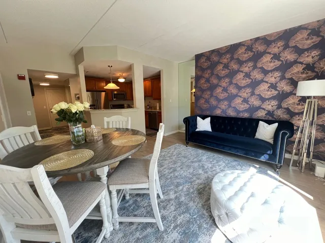 a dining room with furniture and wooden floor