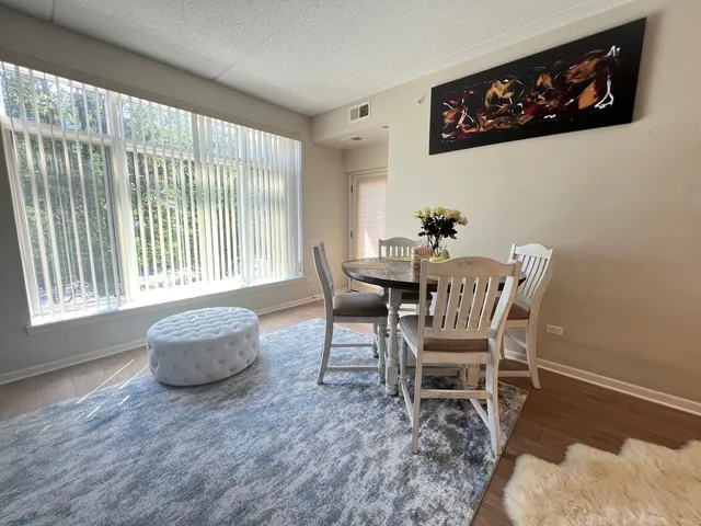 a dining room with furniture and wooden floor