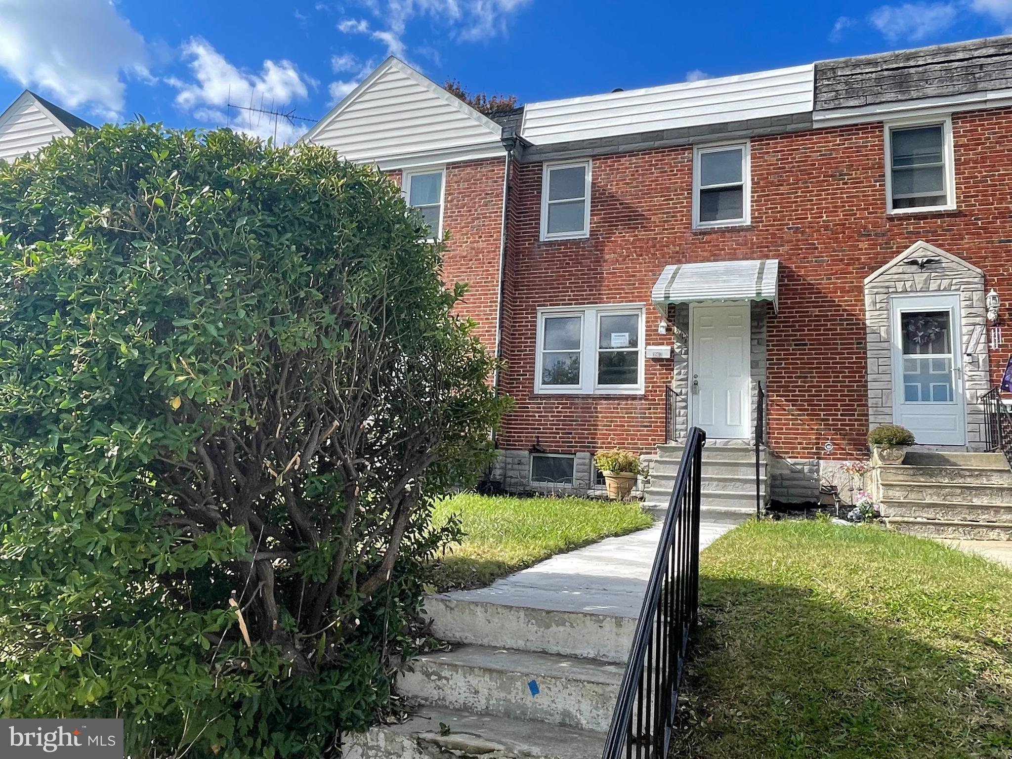 3917 Dudley Avenue Baltimore, MD 21213 - Photo 1 of 23 a front view of a house with garden