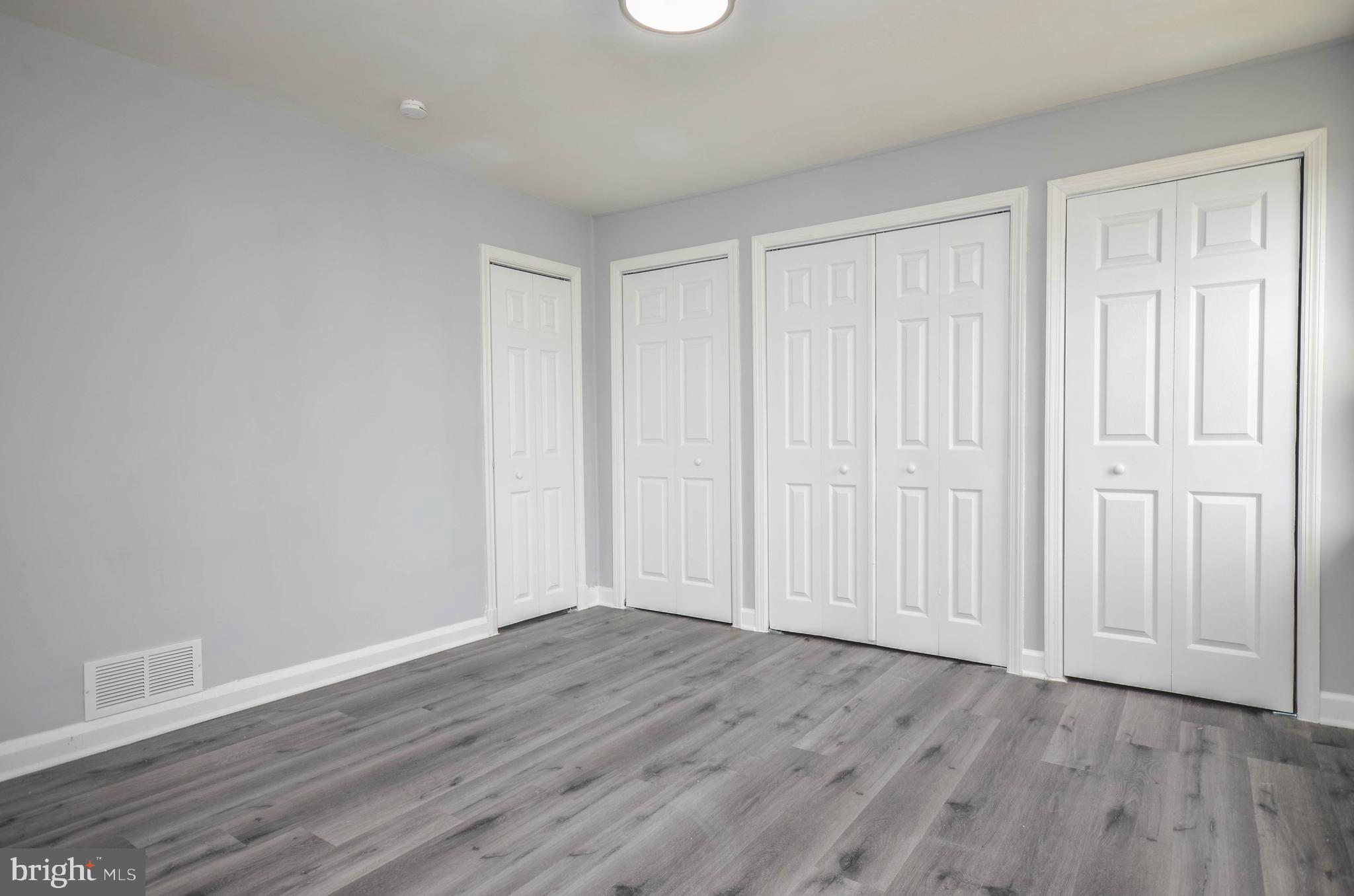 3917 Dudley Avenue Baltimore, MD 21213 - Photo 12 of 23 a view of an empty room with wooden floor