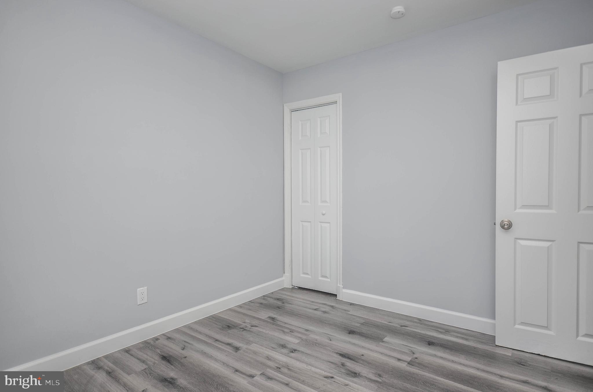 3917 Dudley Avenue Baltimore, MD 21213 - Photo 14 of 23 a view of an empty room with wooden floor