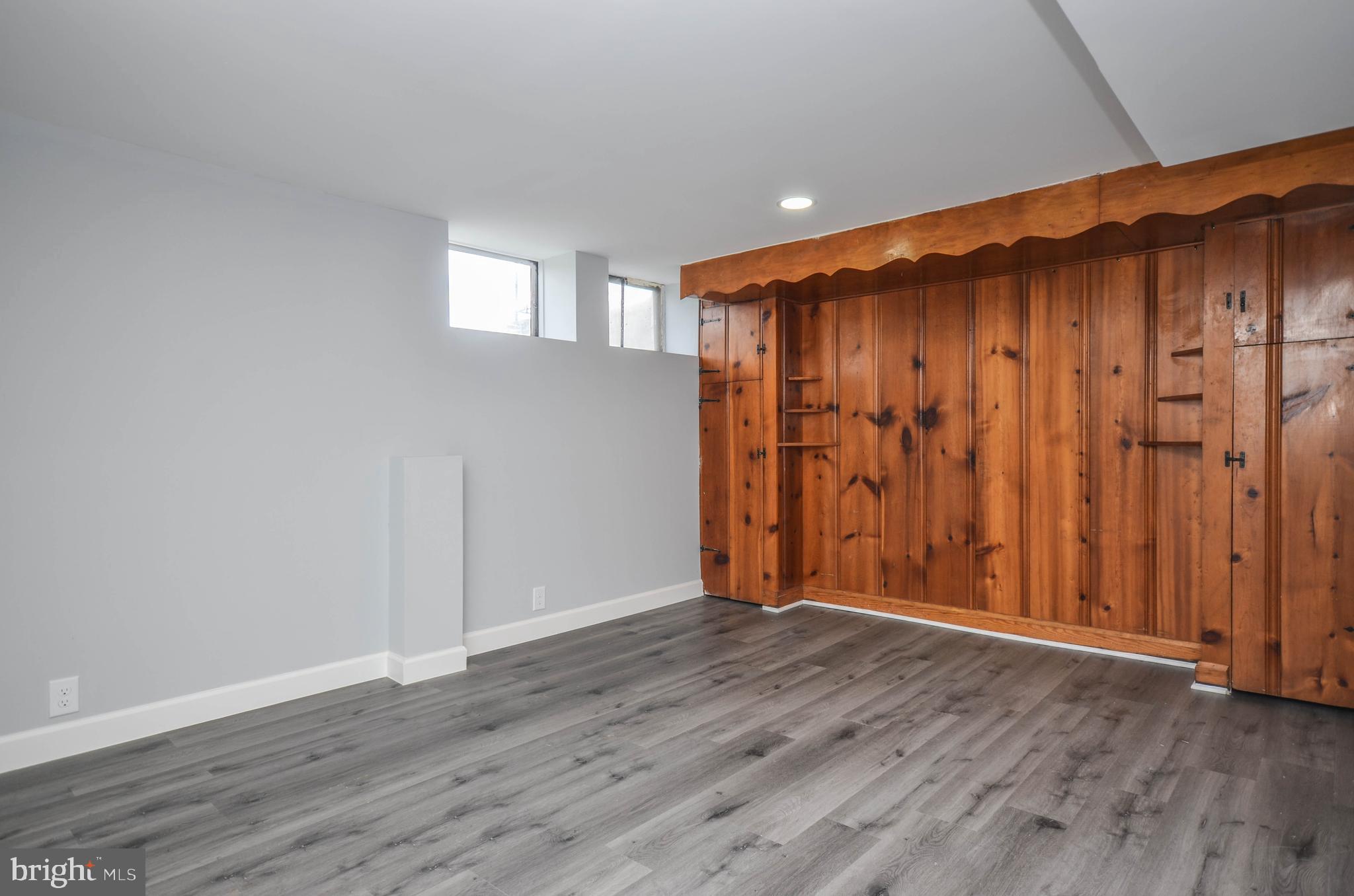 3917 Dudley Avenue Baltimore, MD 21213 - Photo 16 of 23 an empty room with wooden floor and a window