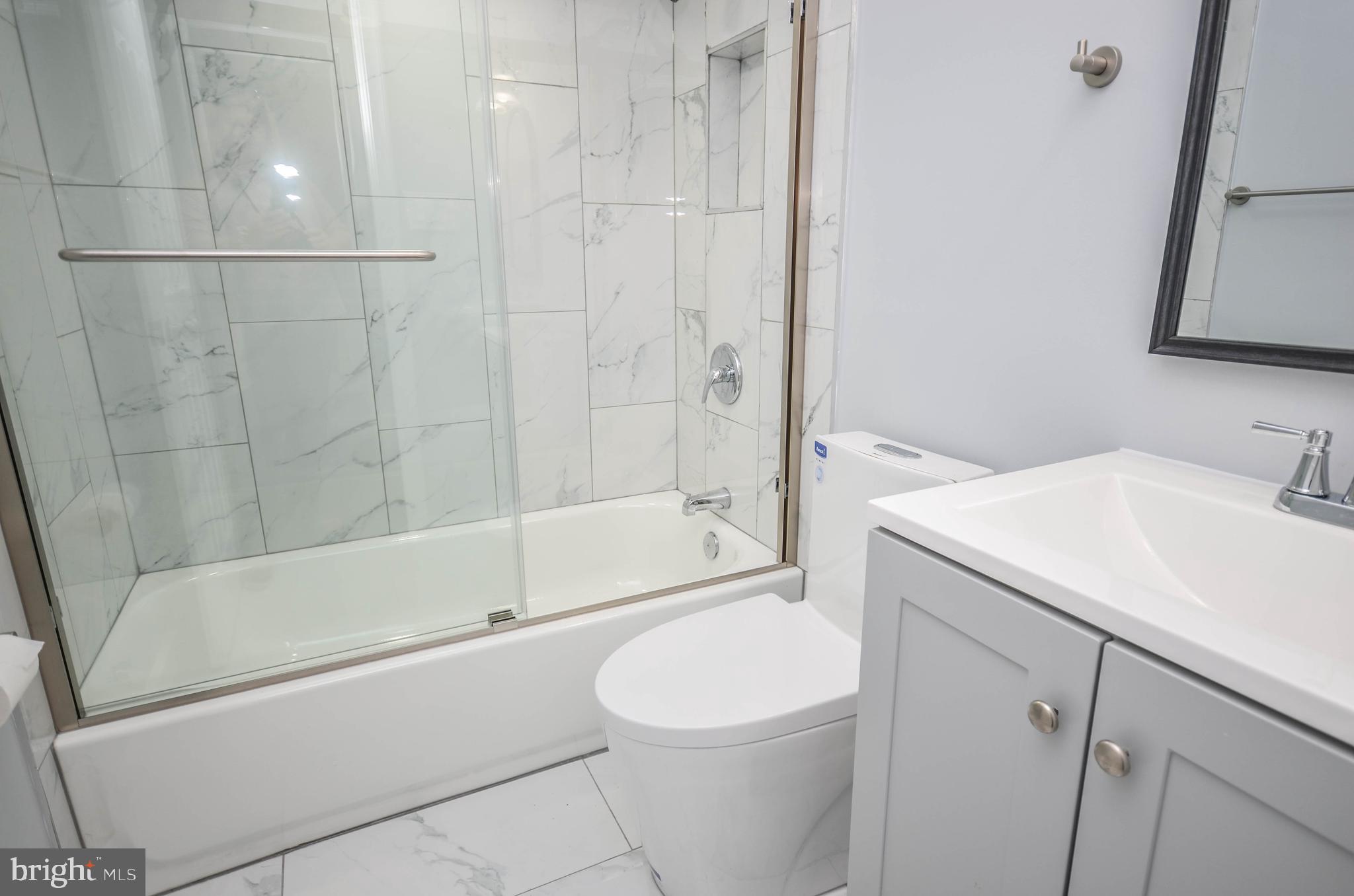 3917 Dudley Avenue Baltimore, MD 21213 - Photo 19 of 23 a bathroom with a sink a toilet and shower