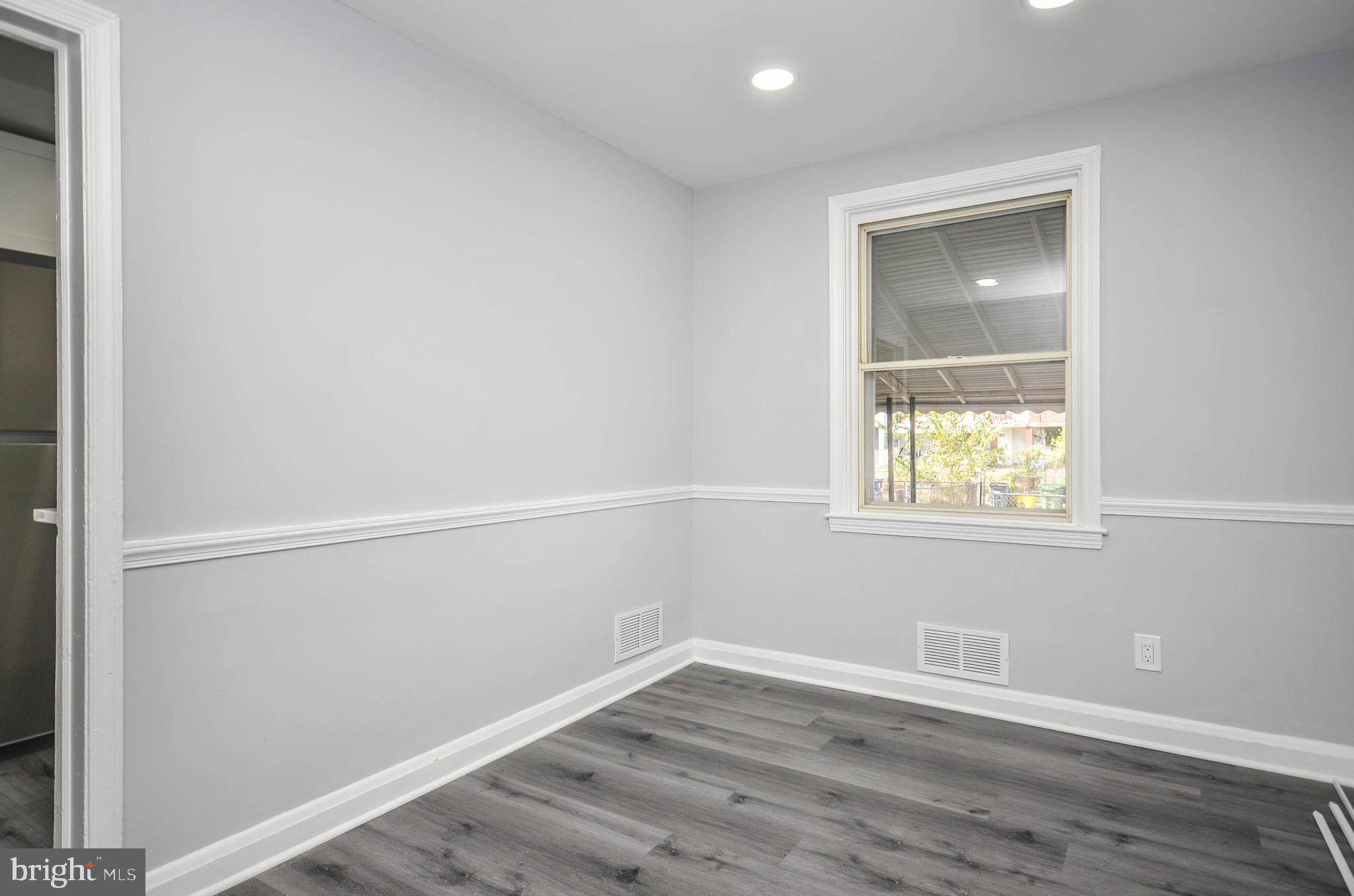 3917 Dudley Avenue Baltimore, MD 21213 - Photo 6 of 23 an empty room with a window