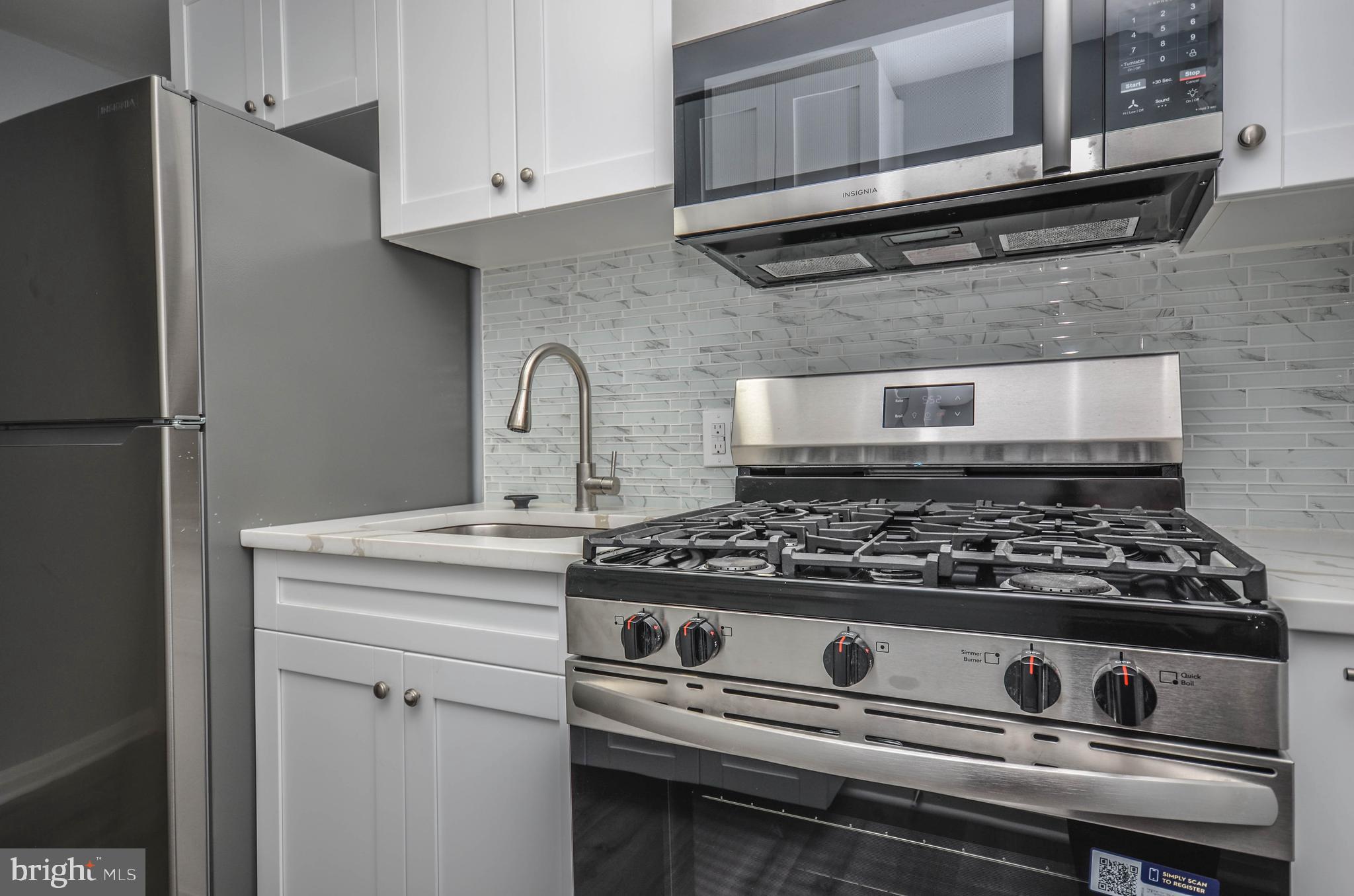 3917 Dudley Avenue Baltimore, MD 21213 - Photo 10 of 23 a stove top oven sitting inside of a kitchen