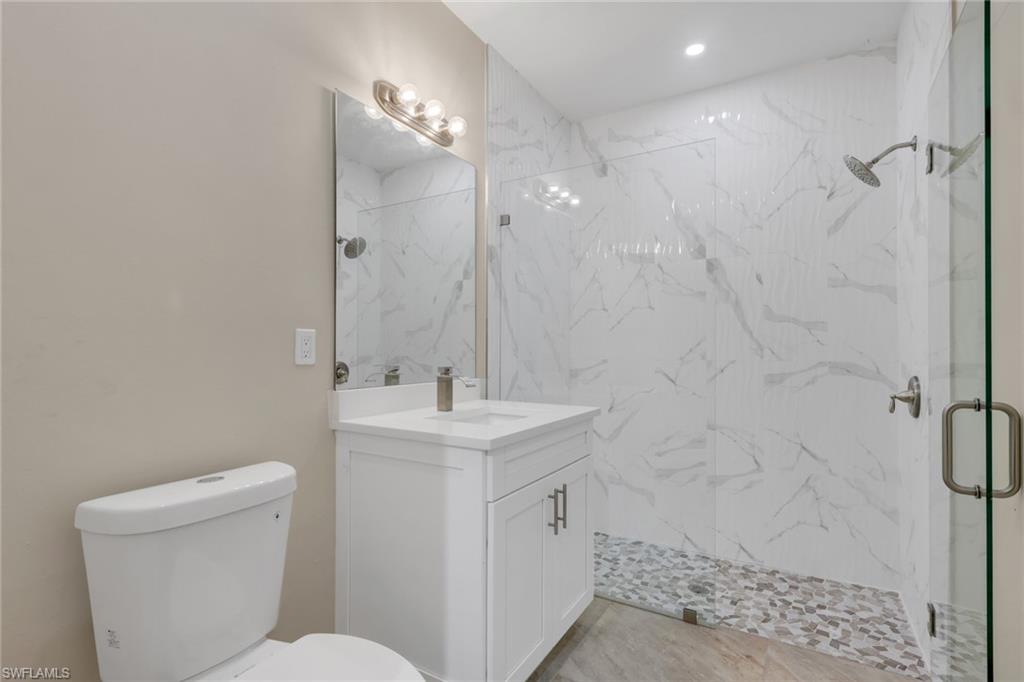 730 29th Street Southwest Naples, FL 34117 - Photo 45 of 50 Bathroom featuring vanity and a marble finish shower