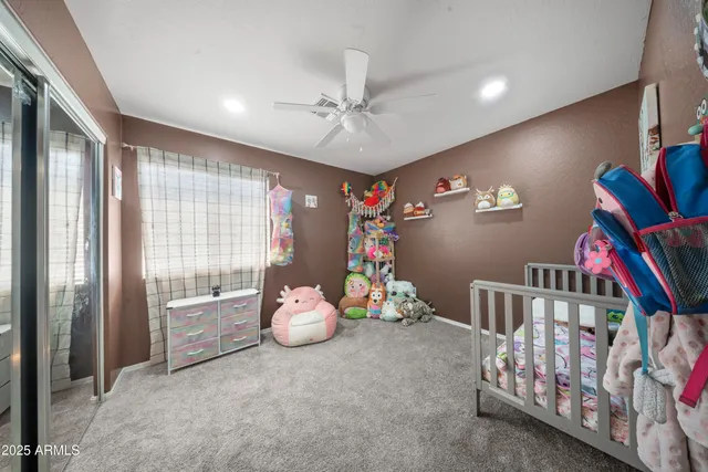 a view of a hallway with a livingroom and a bathroom