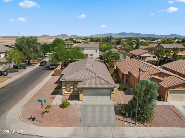 an aerial view of a house with a yard