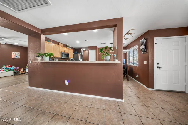 a kitchen with stainless steel appliances kitchen island granite countertop a sink and cabinets