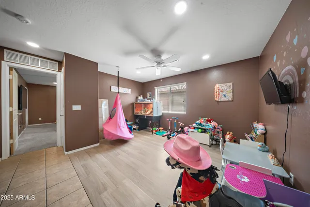 a spacious bedroom with a bed and a chandelier