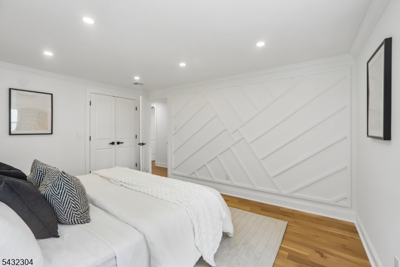 34 Clark Street Summit, NJ 07901 - Photo 17 of 36 a bedroom with a bed and a painting on the wall
