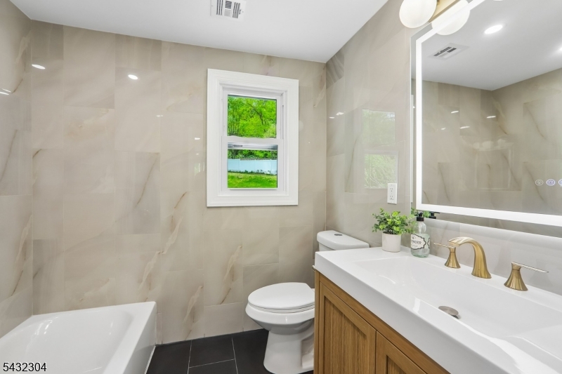 34 Clark Street Summit, NJ 07901 - Photo 18 of 36 a bathroom with a sink toilet and a mirror