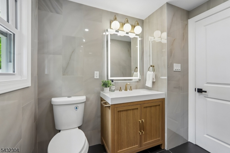 34 Clark Street Summit, NJ 07901 - Photo 19 of 36 a bathroom with a toilet sink and mirror