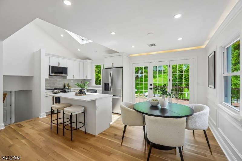 34 Clark Street Summit, NJ 07901 - Photo 7 of 36 a kitchen with a dining table chairs and flat screen tv