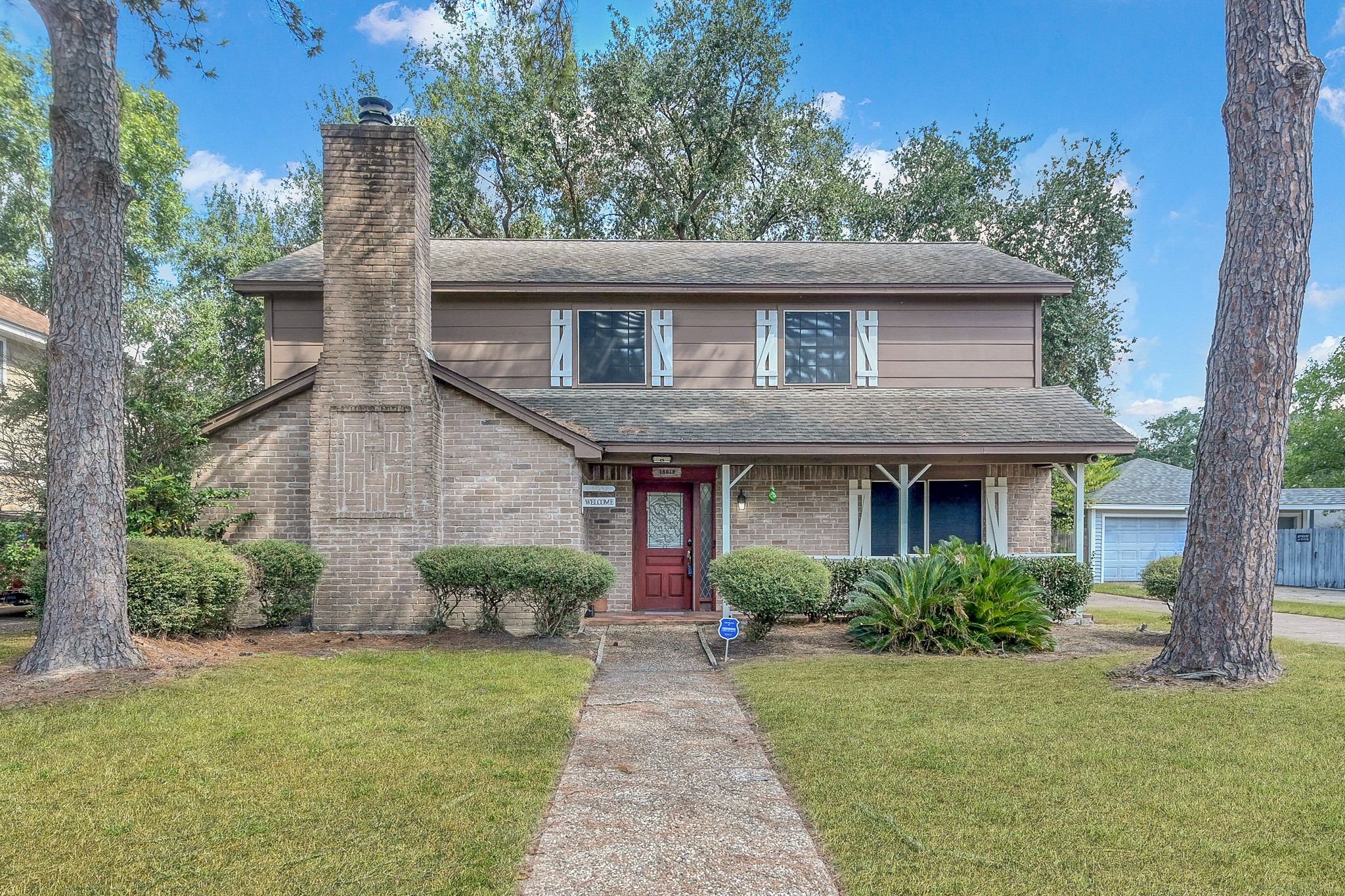 a front view of a house with garden