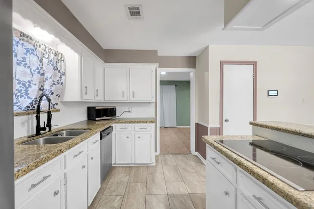 a kitchen with a sink stove and cabinets