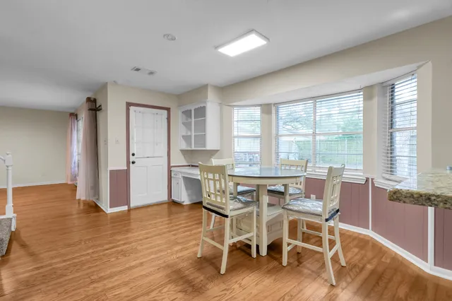 a dining room with furniture and wooden floor