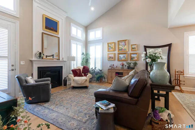 a living room with furniture fireplace and a large window