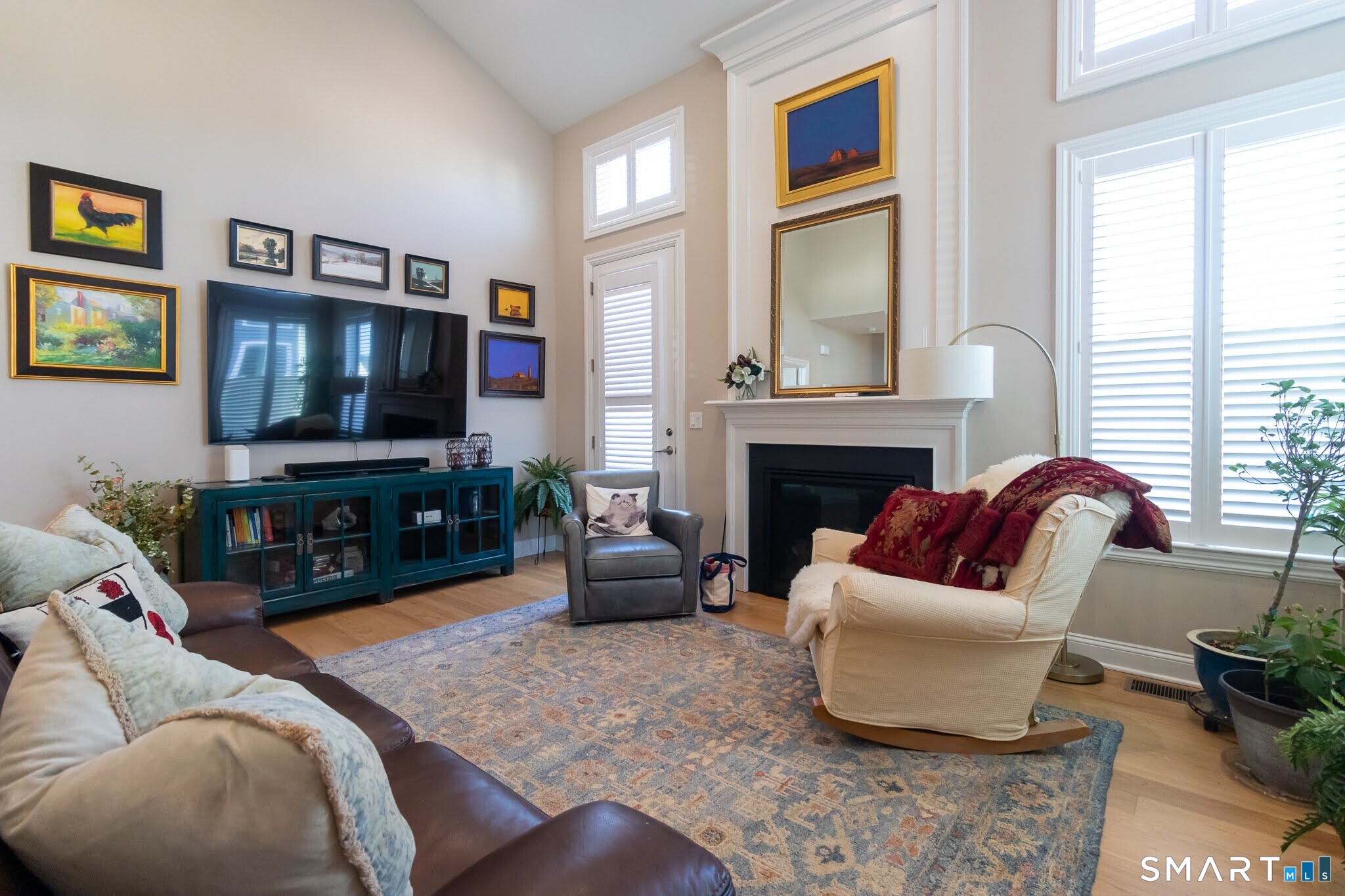 22 Soderman Way Cheshire, CT 06410 - Photo 13 of 40 a living room with furniture a flat screen tv and a fireplace