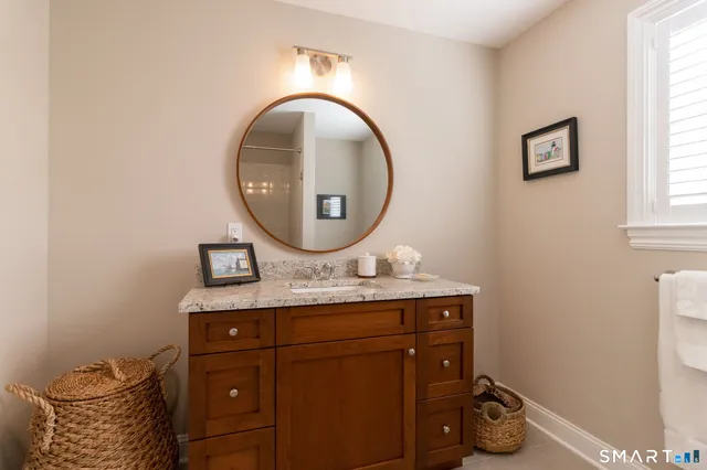 a bathroom with a toilet mirror and vanity