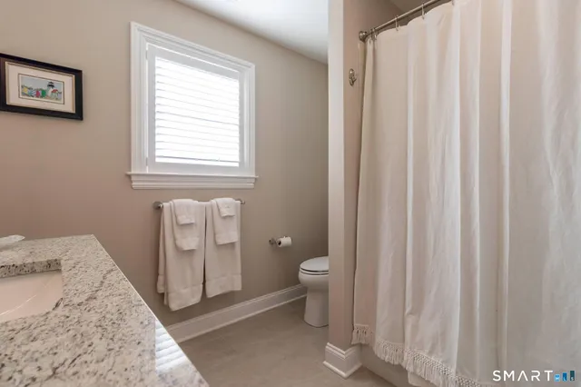 a spacious bathroom with a toilet sink and a shower