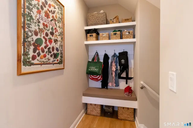 a hallway with painting and a potted plant on th wall