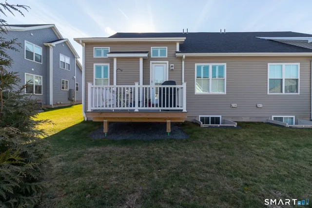 a view of a house with a yard and a deck