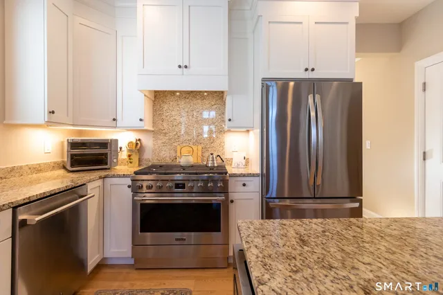 a kitchen with a stove and a refrigerator