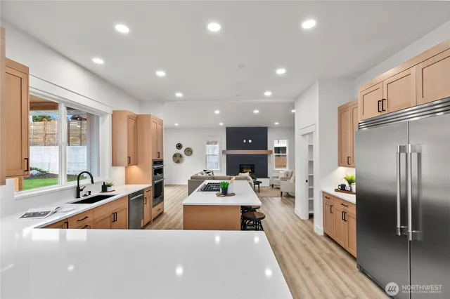 a kitchen with stainless steel appliances a sink and a refrigerator