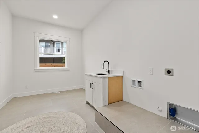 a view of a storage & utility room with a sink