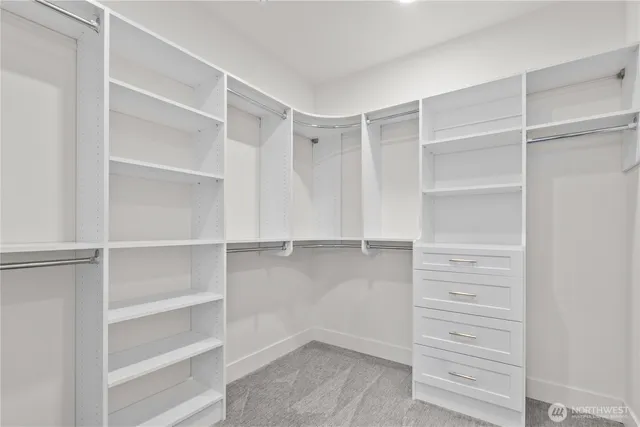 a view of walk in closet with empty racks