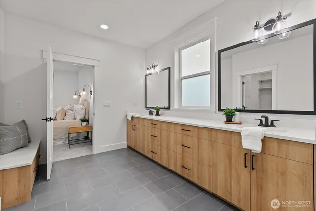 a spacious bathroom with a double vanity sink and a mirror