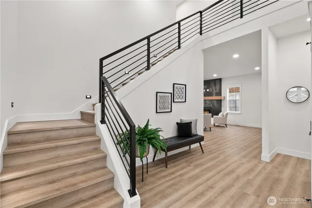 a view of entryway and hall with wooden floor