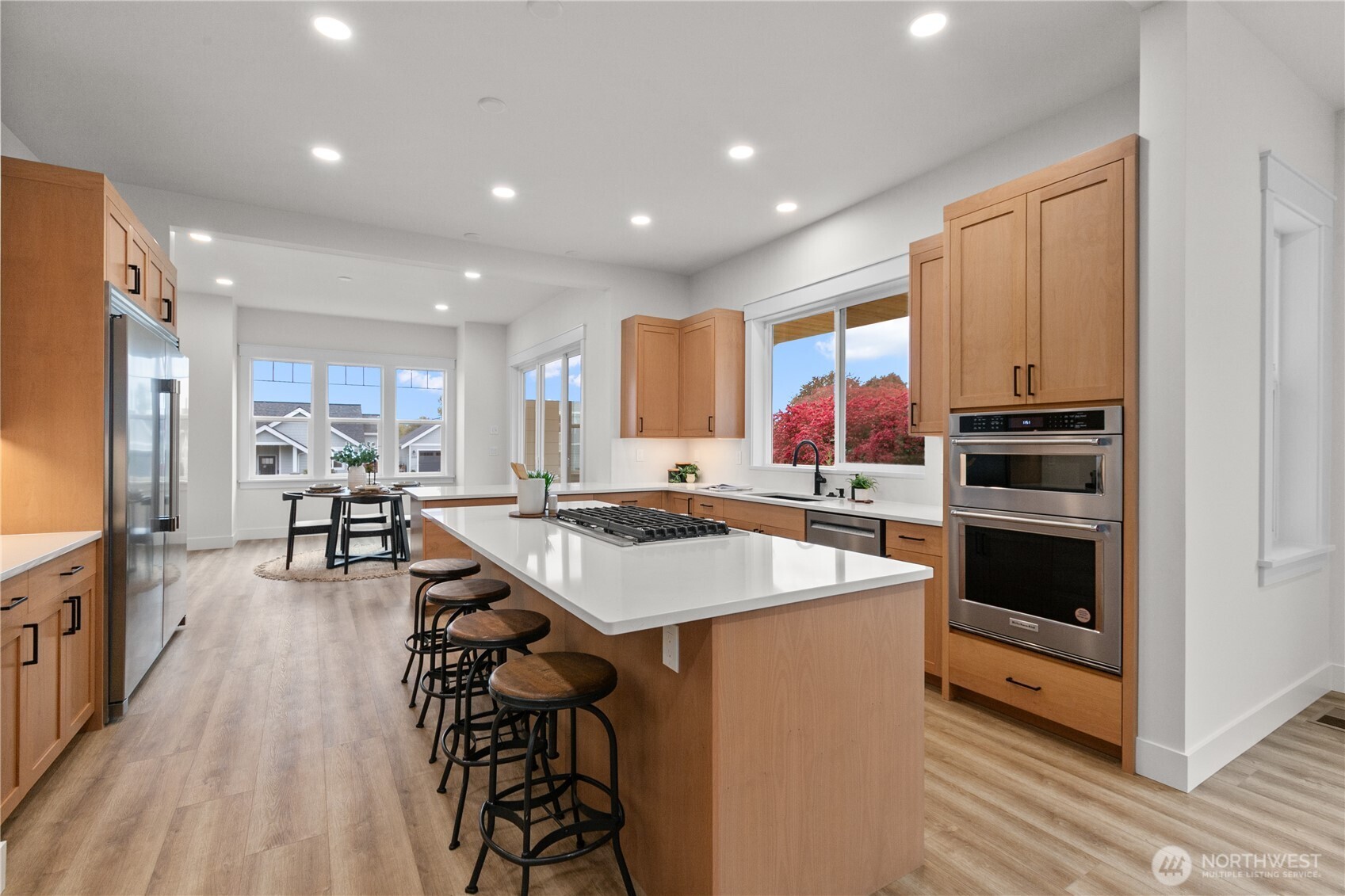 1095 Terrace Drive Lynden, WA 98264 - Photo 10 of 39 a kitchen with kitchen island a stove a table and chairs in it